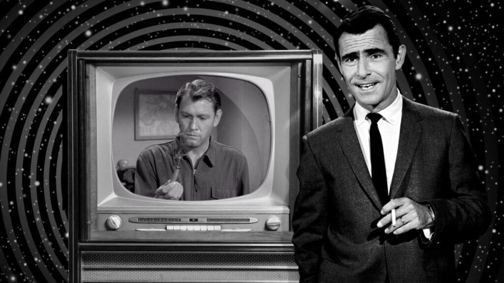 A man in suit and tie standing next to a television.