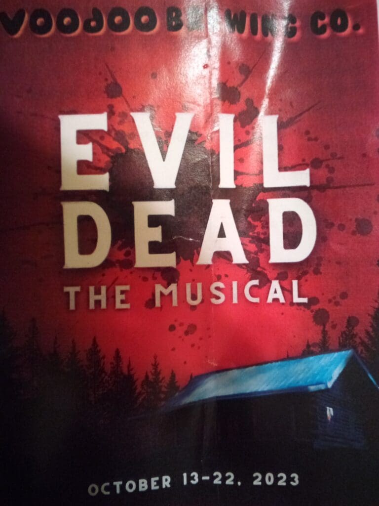 A red sign with the words evil dead the musical on it.