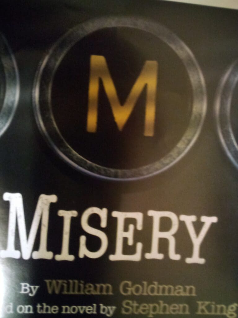 A close up of the word misery on a sign
