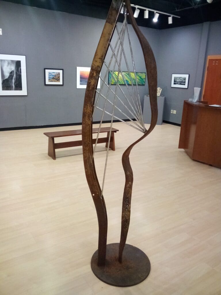 A sculpture of a tree in the middle of an art gallery.