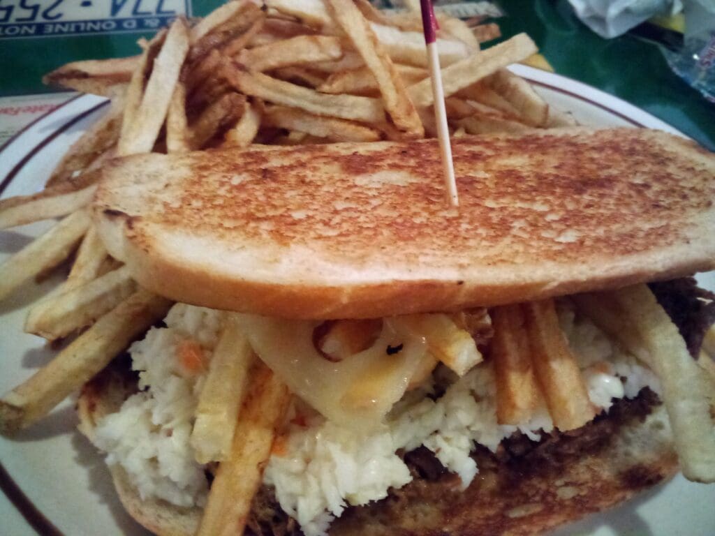 A sandwich and fries on a plate.