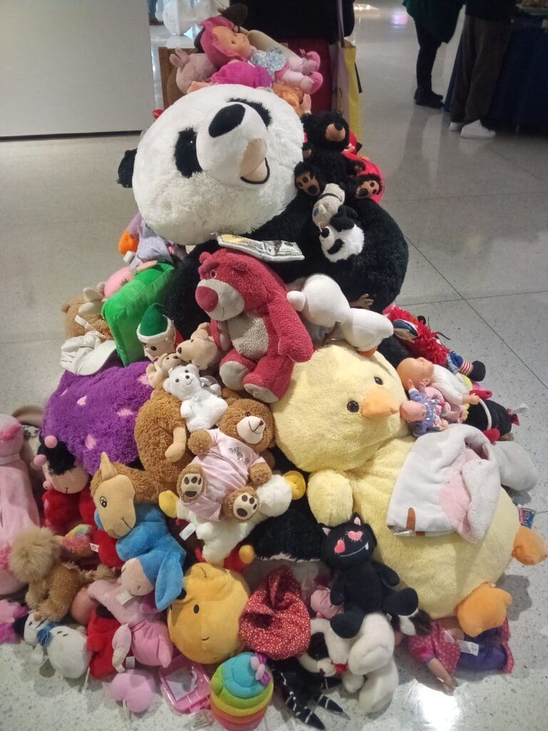 A pile of stuffed animals sitting on top of each other.