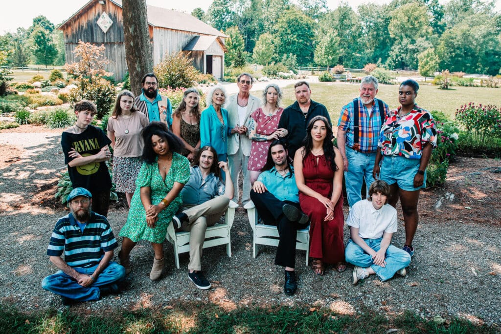 Group of people posing outdoors, smiling.