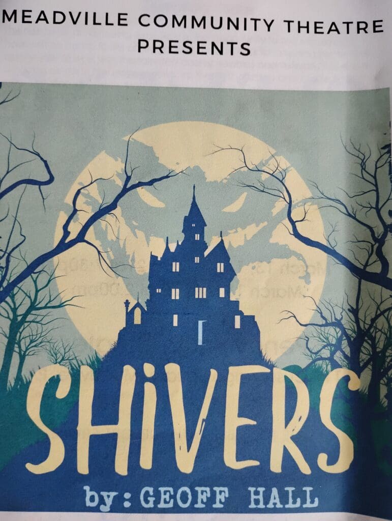 Haunted house silhouette with eerie moon background.