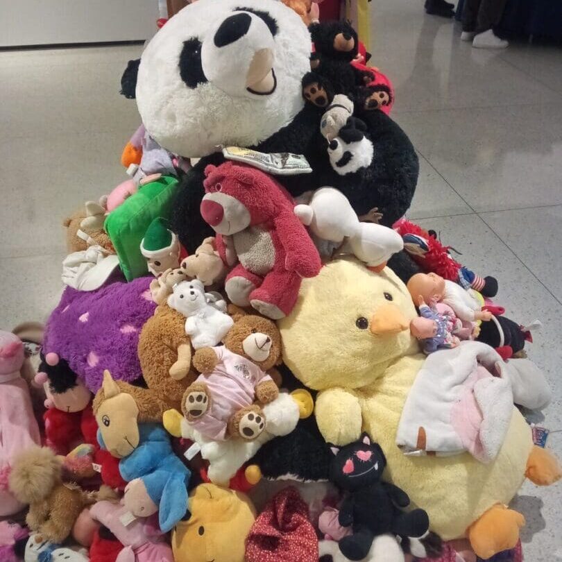 A pile of stuffed animals sitting on top of each other.