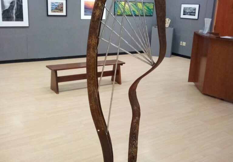 A sculpture of a tree in the middle of an art gallery.