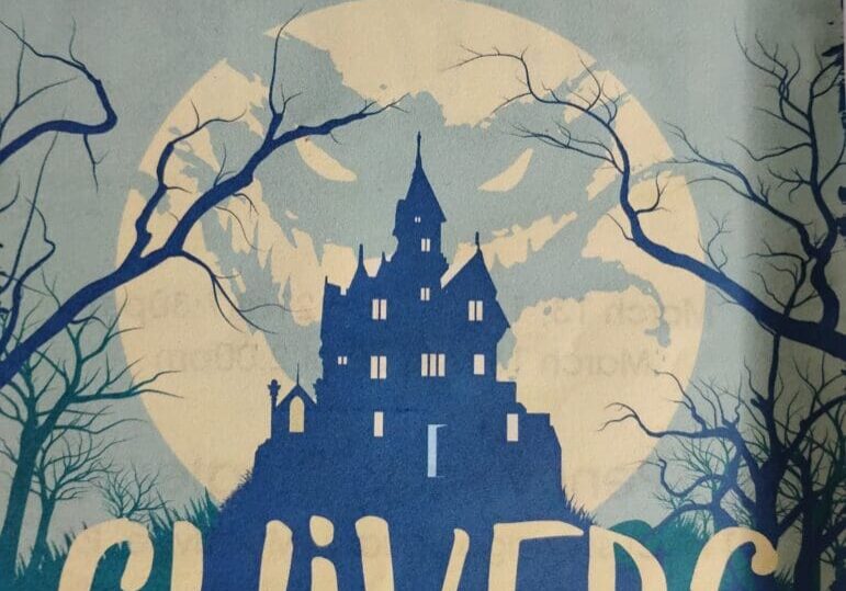 Haunted house silhouette with eerie moon background.