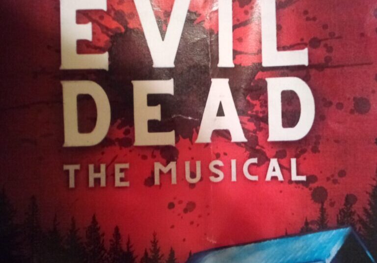 A red sign with the words evil dead the musical on it.