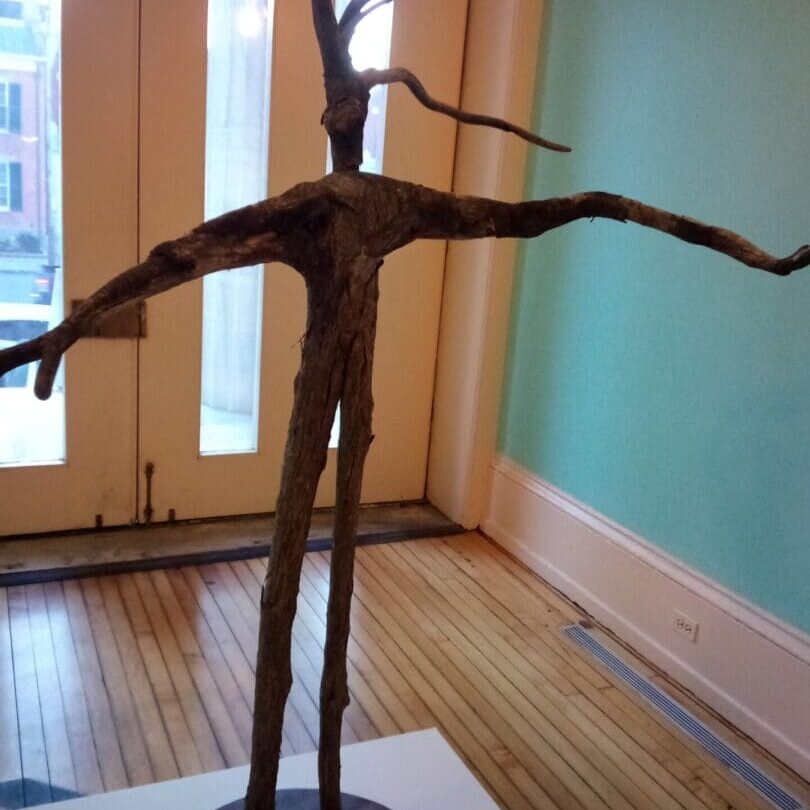 A sculpture of a tree in the middle of a room.