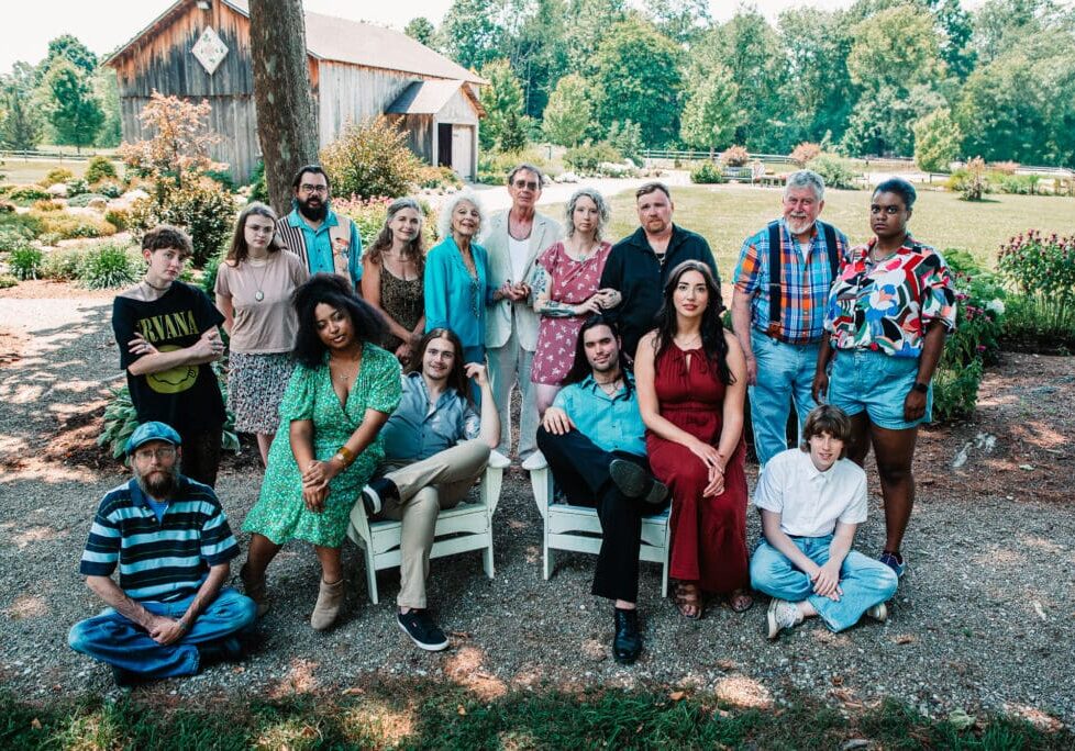 Group of people posing outdoors, smiling.