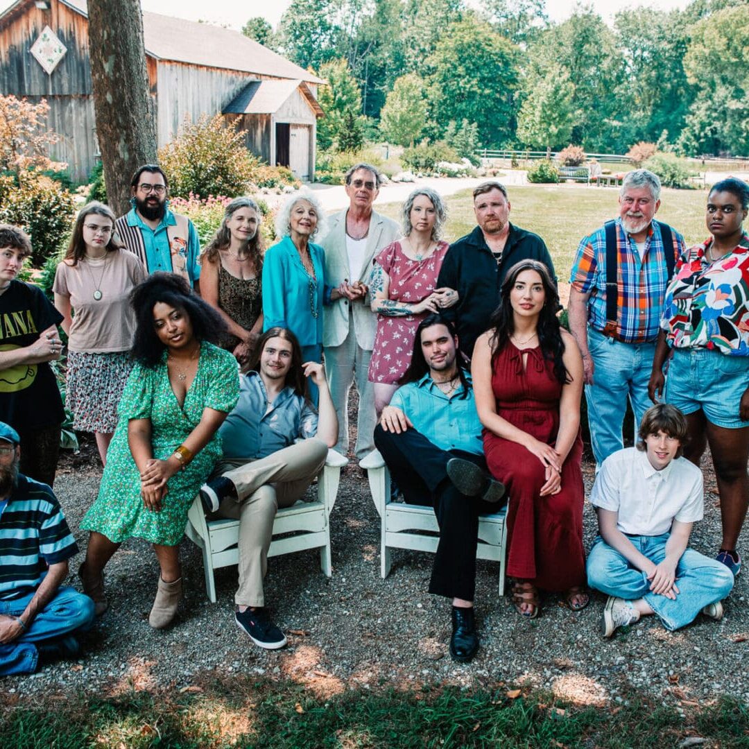 Group of people posing outdoors, smiling.