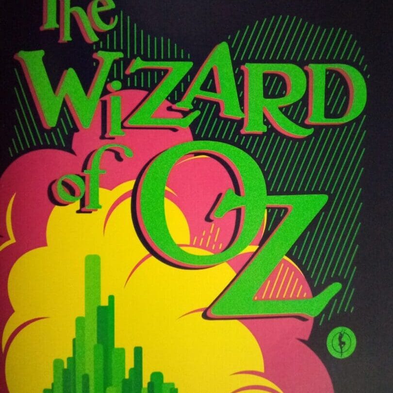 A wizard of oz book cover with the yellow brick road.